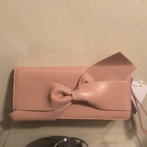 Soft pink bow tie clutch bag